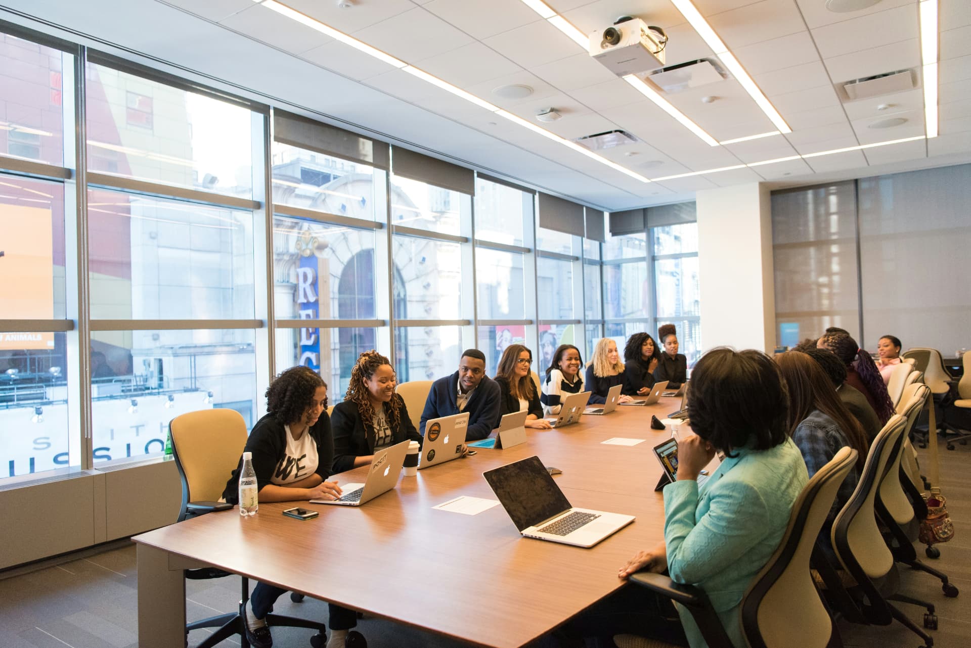 A group of professionals talking around a long conference table
